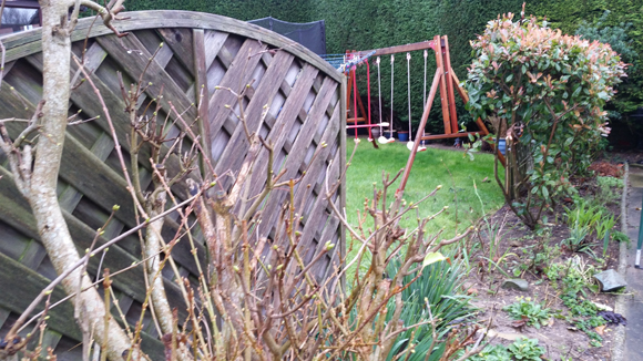 Wind damaged decorative arched panel fencing.
