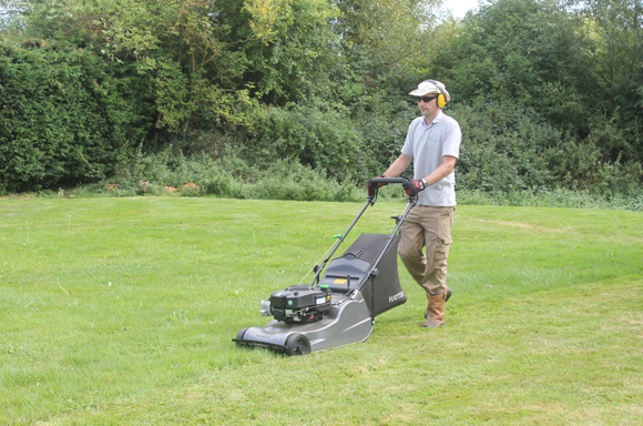 mowing a lawn gardener lawn mowing