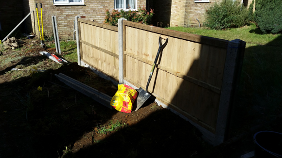 Small fence being built in a front garden.